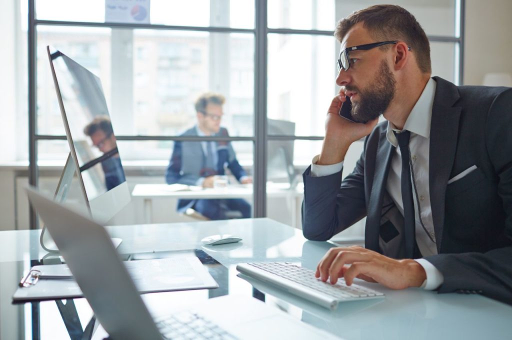 man in office on phone