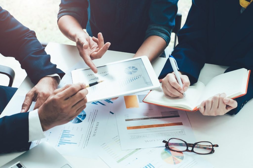 group of workers viewing a tablet
