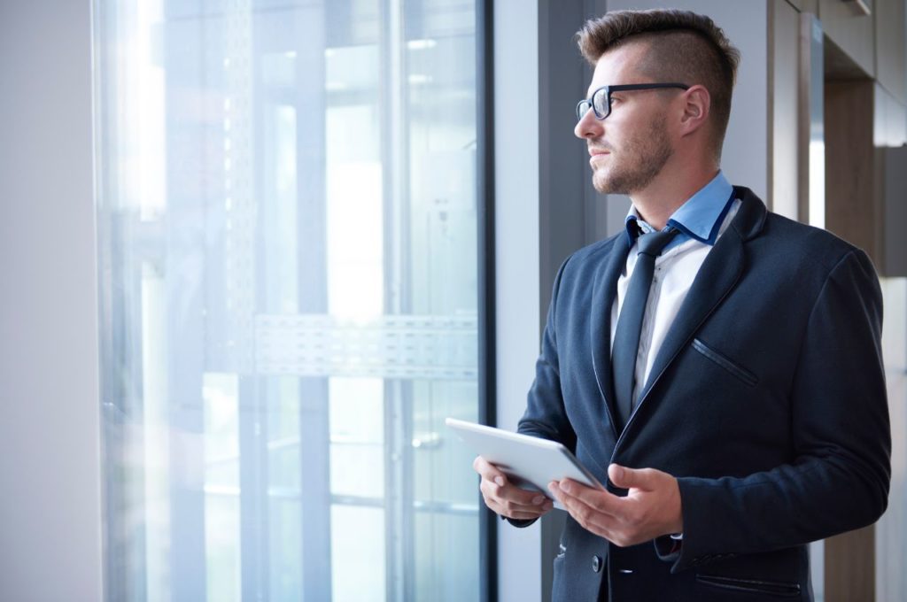 business man looking out window
