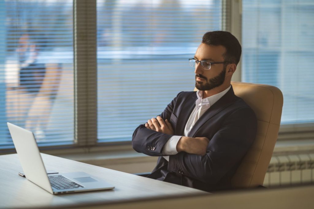 man in office looking at computer