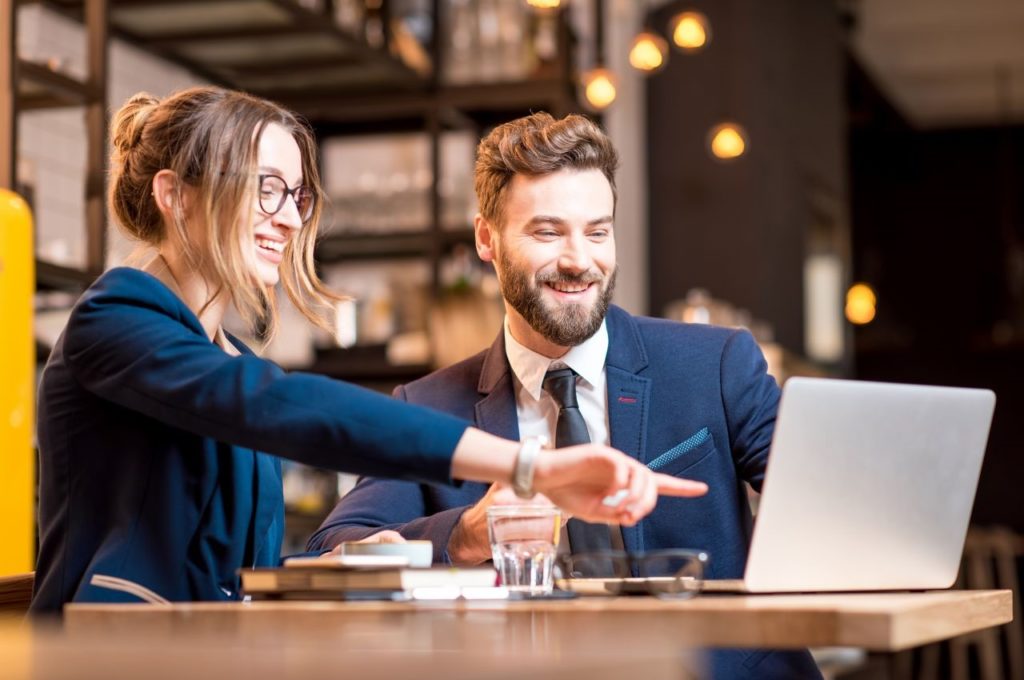 woman and man looking at a computer together